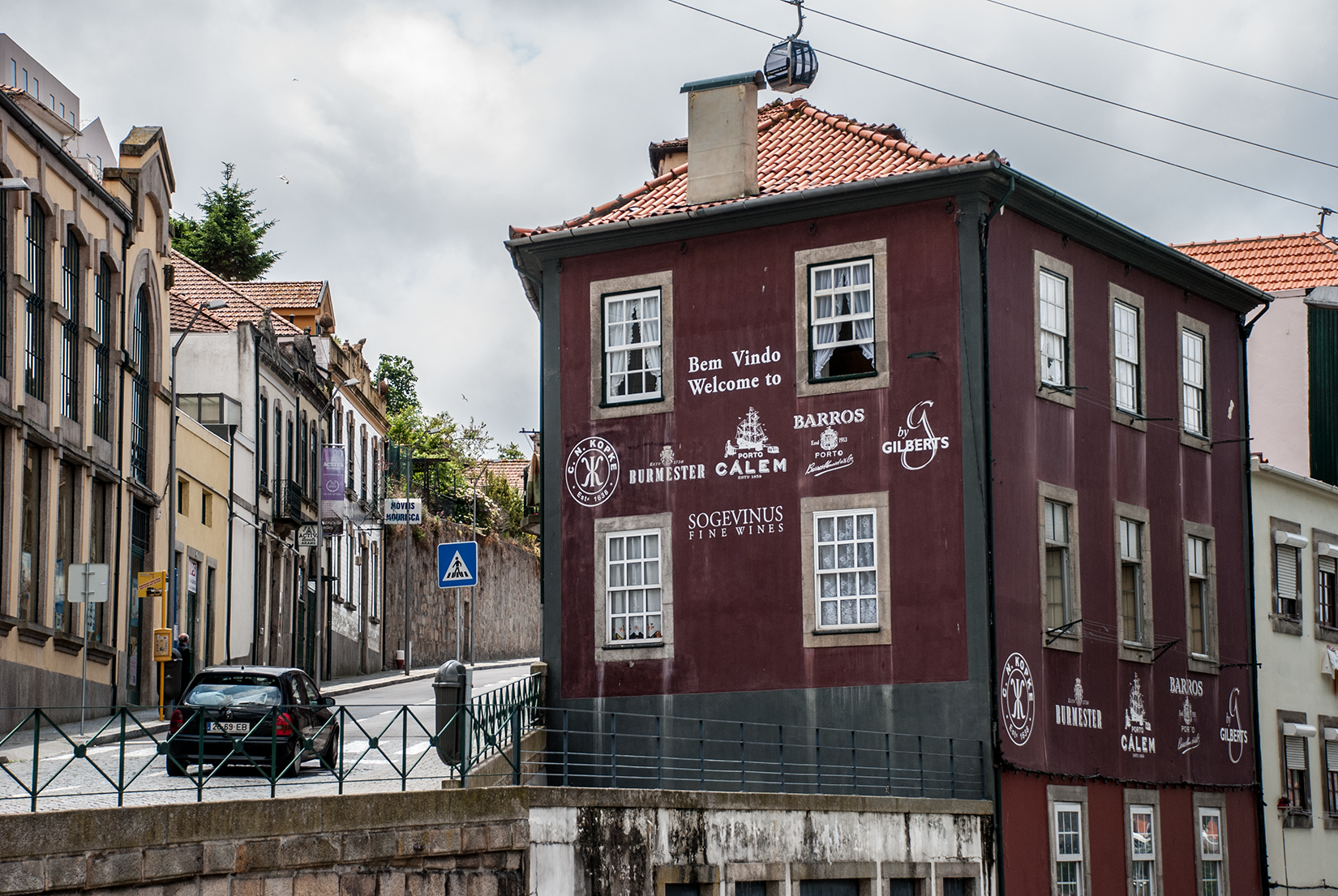 One of the old sherry lodges at Vila Nova de Gaia, with the Teleférico de Gaia cable car running overhead