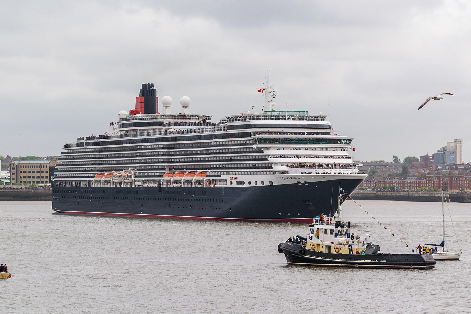 Queen Victoria starts her manouver opposite the Liverpool Echo Arena