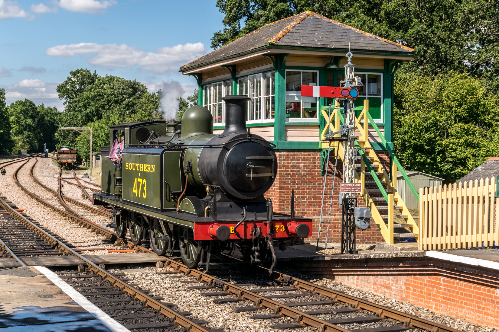 B473 pausing at Kingscote station signal box before completing its run around the goods wagons