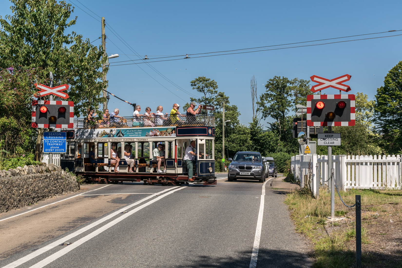 Car 8 heading south across the road at Colyford level crossing