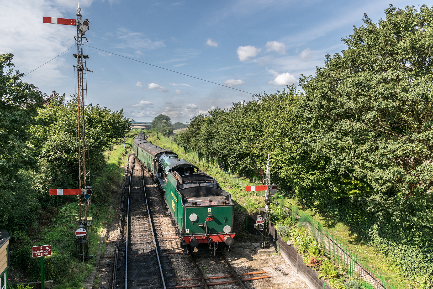 850 'Lord Nelson' pulling into Ropley station with an Alton bound train from Alresford