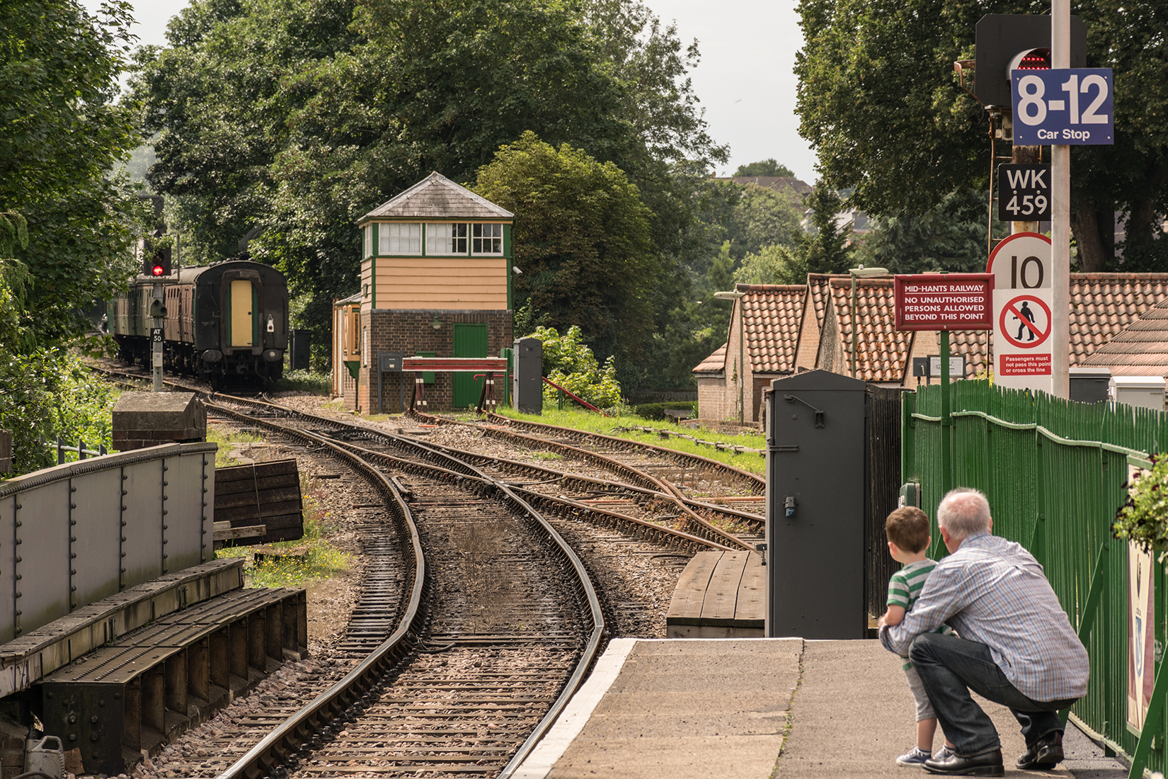 Young boy watches with his grandfather as the 12:50 'down' leaves Alton