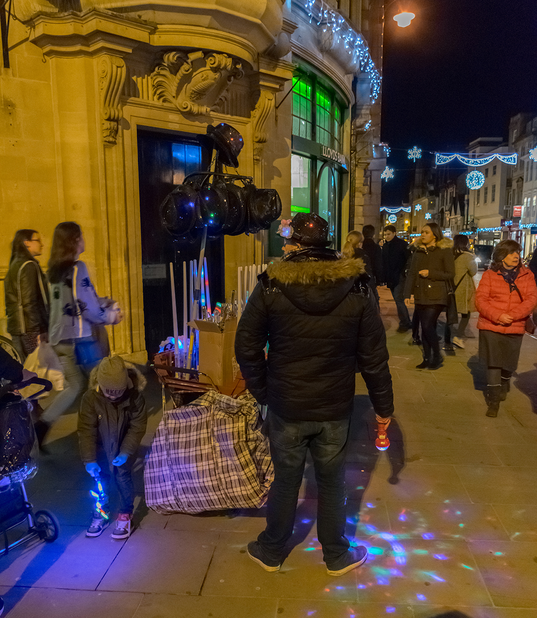 Street trader and customer both lighting the way