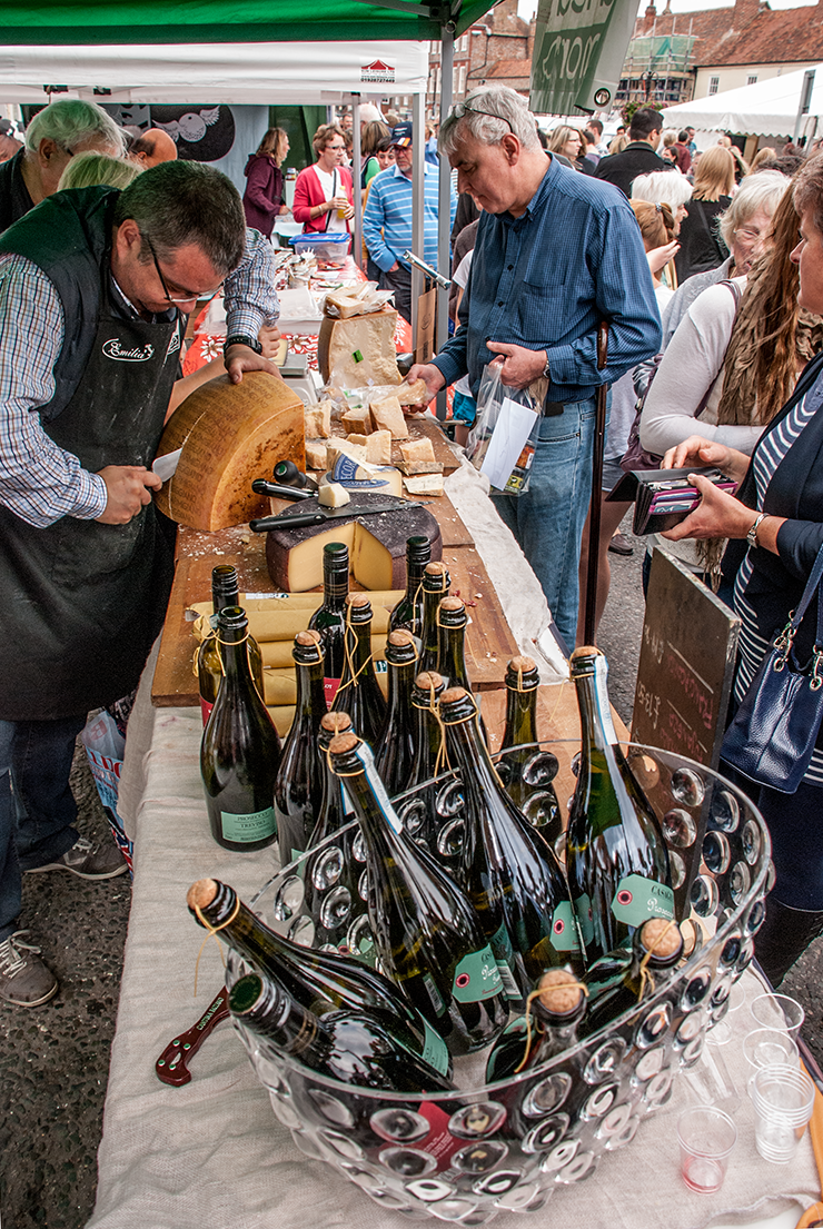 Cutting a whole Parmigana cheese for sale