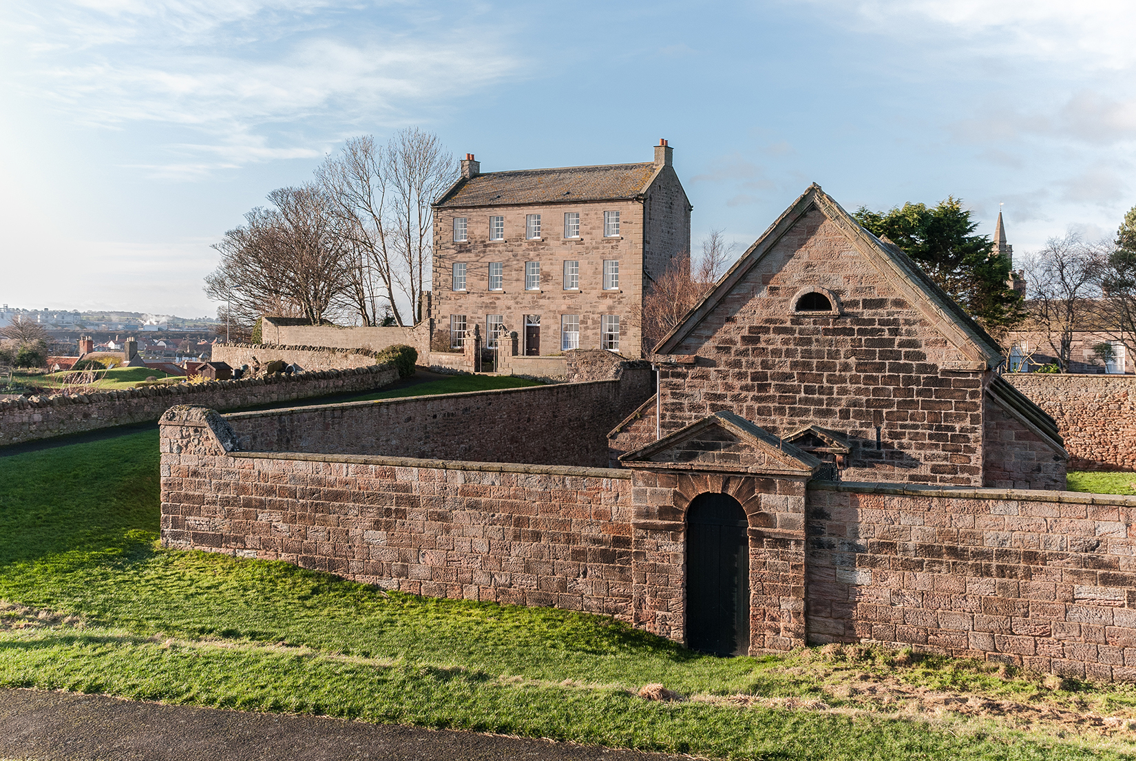 The Lion House (background) and the 18th century Gunpowder Magazine (foreground)